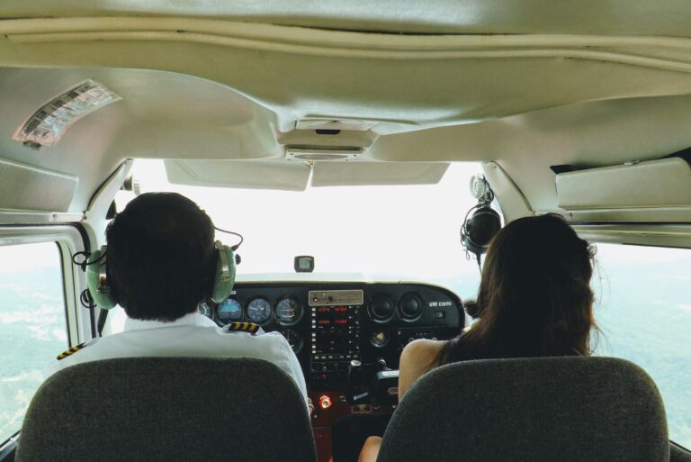 Two pilots in a cockpit navigating through the skies over Blumenau, Brazil, providing a unique aviation perspective.