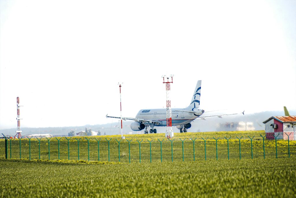 Passenger aircraft taxiing on runway at Beograd Airport, Serbia, with clear blue sky.